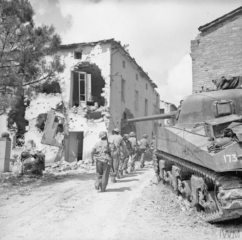 Infantry of 6 Inniskillings pass an Ontario Regiment tank in Pucciarelli on 25 June 1944. IWM UK National Archives 16442. Photographer Sgt Menzies.
