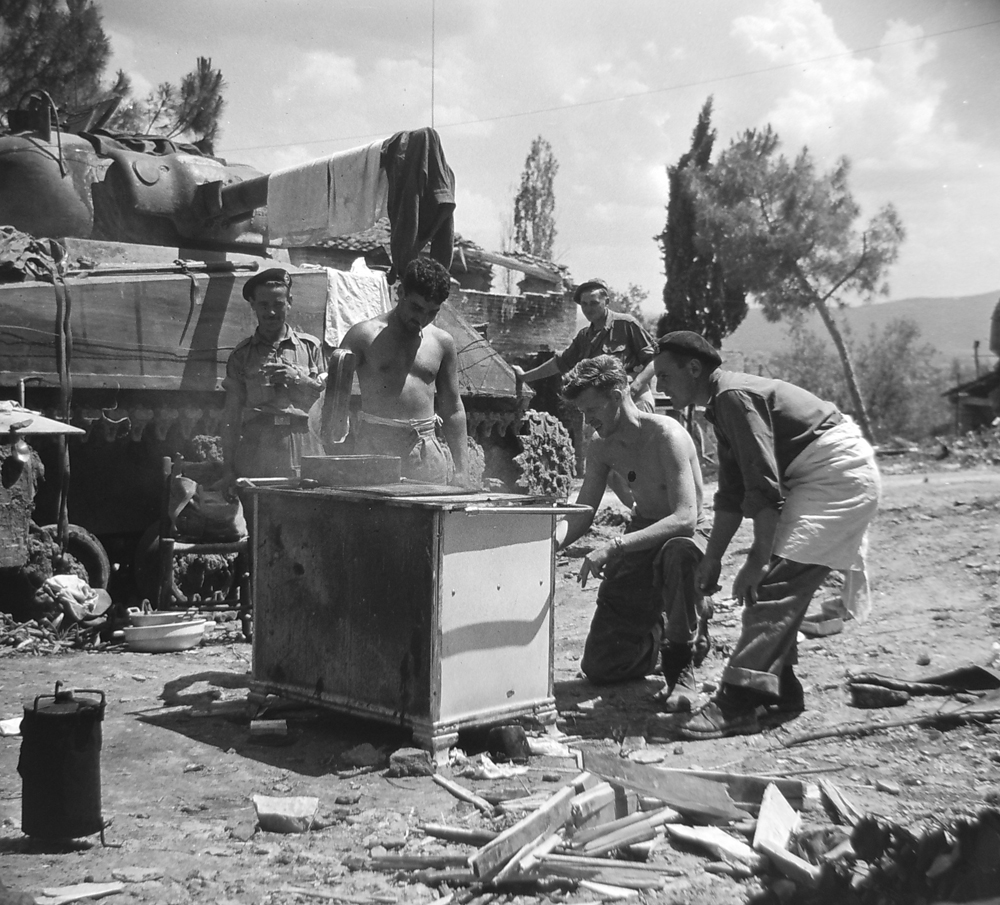 A crew roasting a pig on 28 June near Pucciarelli. 
Trooper Frederick Hoshoian (Galt, ON) is at far left. Others in the photo are Troopers Harry Turner (Toronto), William Kerr (Montreal) and Allie Rix (Toronto). DND/Library and Archives Canada/PA-201345.
